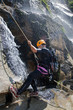 Men descending waterfall