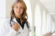 Smiling young female doctor outdoors