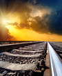 railway to horizon under dramatic sky with sun railway to horizon under dramatic sky with sun