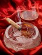 cuban cigar and and glass liquor over red satin cuban cigar and and glass liquor over red satin