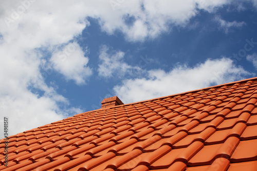 Photo: New red rooftop against blue sky New red rooftop against blue sky