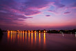 Lights reflex on river against sunset background