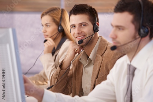 Photo: Cheerful young male dispatcher working Cheerful young male dispatcher working