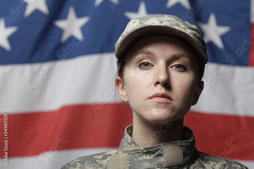 Photo: Female soldier in front of US flag Female soldier in front of US flag