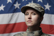 Female soldier in front of US flag