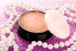makeup powder on pink background