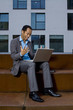Smart business man working outdoors with laptop an wireless LAN