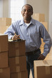 African man with clipboard and moving boxes