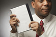 African businessman holding datebook