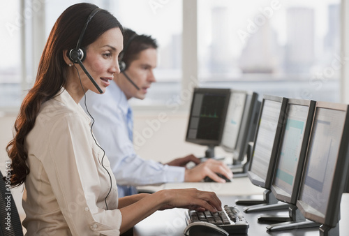 Photo: Hispanic businesswoman working on computer Hispanic businesswoman working on computer