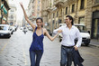 Couple holding hands in street