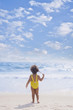 Hispanic girl standing on beach