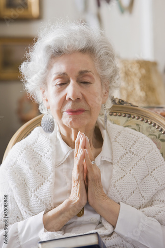 Photo: Senior Hispanic woman praying Senior Hispanic woman praying