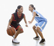Mixed race women playing basketball