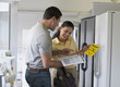 Hispanic couple shopping for refrigerator