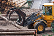 Skidder hauling logs at sawmill.