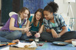 Teenage girls looking at cell phone