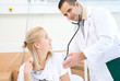 The doctor listens to a stethoscope to the patient