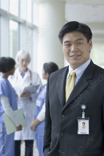 Photo: Chinese businessman in hospital with doctors and nurses Chinese businessman in hospital with doctors and nurses