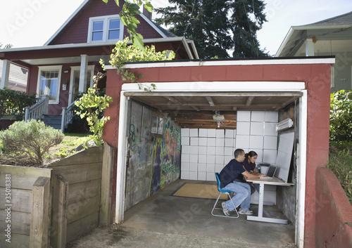 Photo: Couple operating small business in garage Couple operating small business in garage