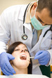 Image of a dentist curing a girl
