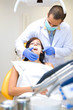 Image of a dentist curing a girl