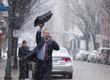 Caucasian businessman hailing taxi in snow