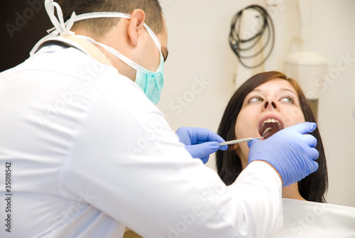 Photo: Image of a dentist curing a girl s teeth Image of a dentist curing a girl s teeth