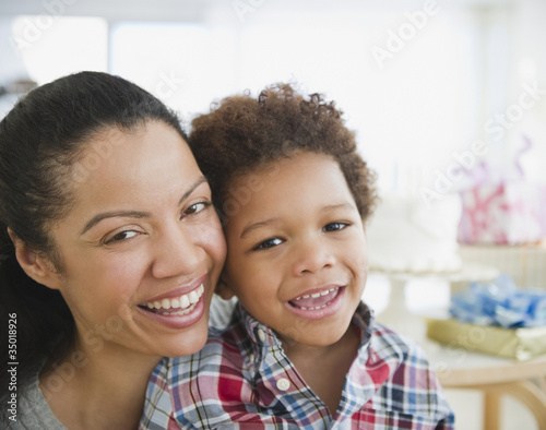 Photo: Mixed race mother smiling with son Mixed race mother smiling with son