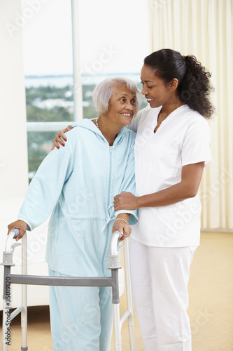 Photo: African American nurse helping senior woman with walker African American nurse helping senior woman with walker