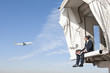 Hispanic businessman sitting on jetway