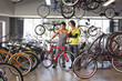 Bike shop owner helping customer choose bicycle
