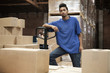 Black man standing in warehouse