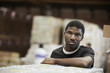 Black man standing in warehouse