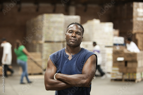 Photo: Black man standing in warehouse Black man standing in warehouse