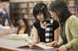Filipino librarian helping student in school library