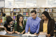 Librarian helping students in school library