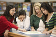 Librarian helping students in school library