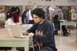 Student with laptop in school library