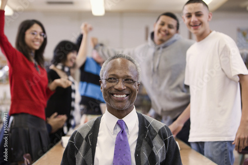 Photo: Librarian with cheering students in school library Librarian with cheering students in school library