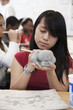 Pacific Islander student working with clay in classroom