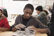 Student working with clay in classroom