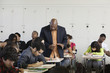 Teacher talking to student in classroom