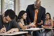 Teacher talking to student in classroom