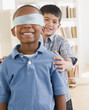 Boy spinning friend wearing blindfold