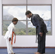 African American boy practicing karate with sensei