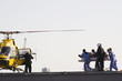 Medical personnel rushing patient to helicopter