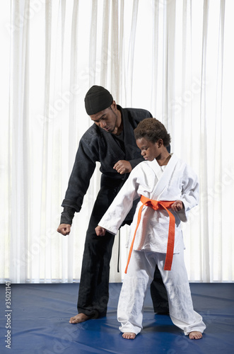 Photo: African American boy practicing karate with sensei African American boy practicing karate with sensei