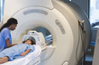 Doctor preparing patient for MRI