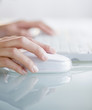 Hands operating computer mouse and keyboard